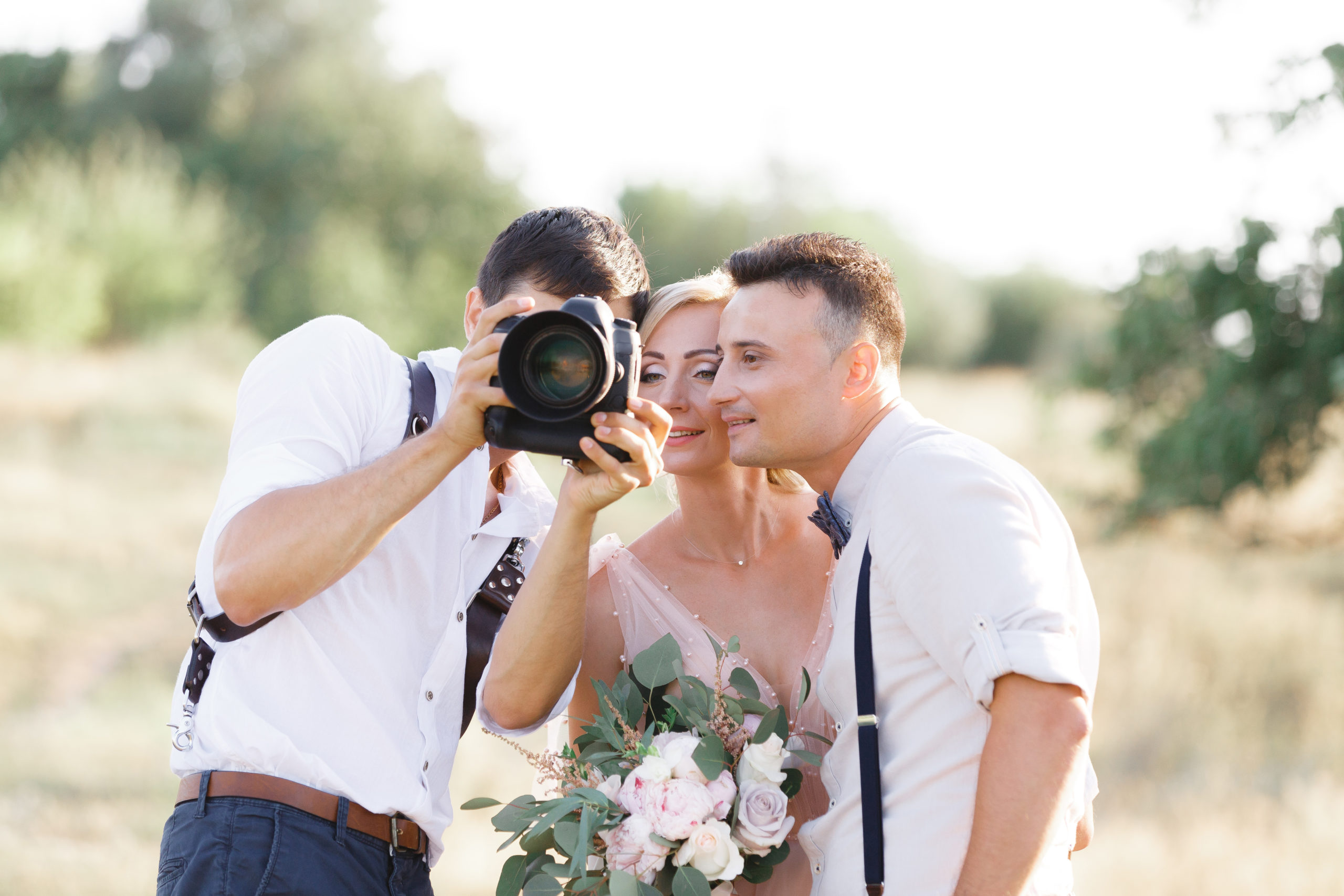wedding photographer takes pictures of bride and groom